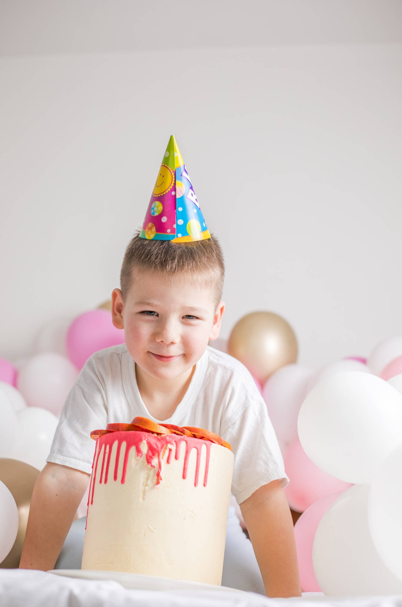 Small child with party balloons, celebration. Birthday, happiness, childhood, look.